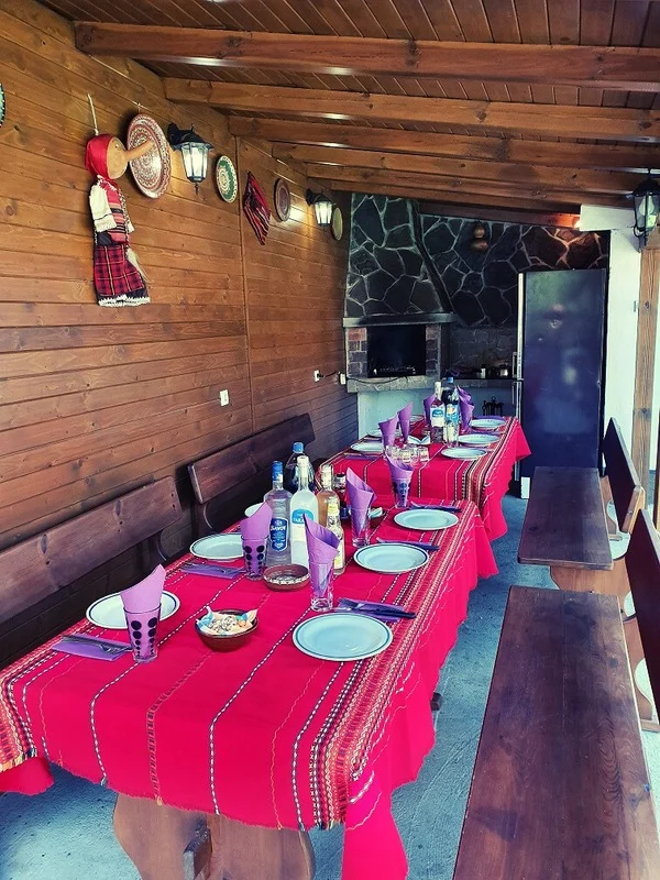 The same barbecue in the garden from a different angle, but this time with tables full of plates, glasses and etc.